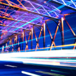 Photo of light lines from fast moving vehicle on a bridge